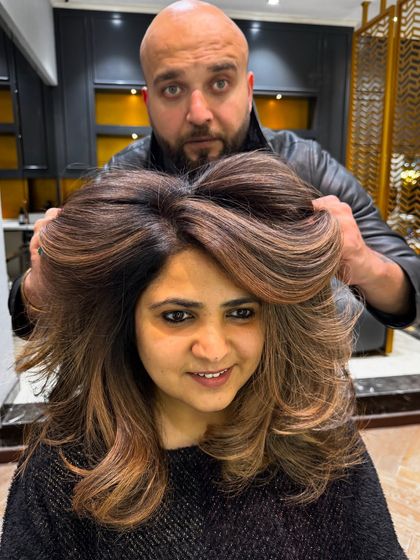 Hair color is an accessory, and this look proves it. The voluminous styling and beautiful brown tones create a stunning, glamorous effect.