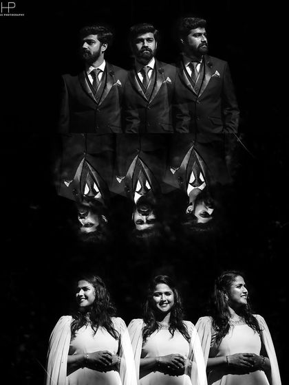 An artistic black and white reflection shot of the groomsmen and bridesmaids from a pre-wedding event.