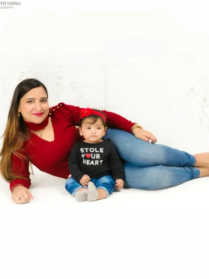 A sweet mother-daughter portrait. The baby's shirt, "Stole Your Heart," adds a playful and personal touch to this lovely photo.