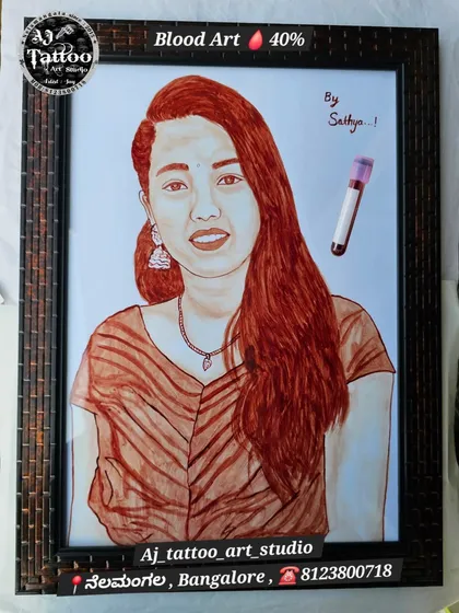 This custom blood portrait was signed "By Sathya," indicating it was a gift. The artwork captures the subject's direct gaze and is a beautiful example of a personalized present.