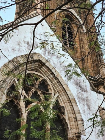 A dynamic shot looking up at the church, its weathered facade telling stories of time.