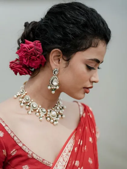 A side profile showcasing the elegant updo and the beautiful jewelry.