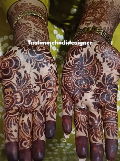 A full view of a beautiful floral design with a deep, mature henna stain. The pattern covers the entire palm with blooming flowers and leaves, perfect for any festive occasion.