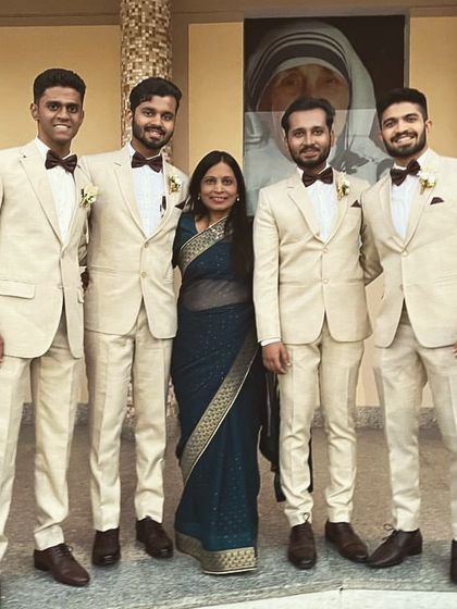 The groomsmen looking dapper in their beige suits and brown bow ties. I provided the matching white floral boutonnieres to complete their coordinated wedding day look.