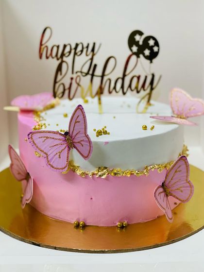 A simple yet beautiful butterfly cake with a "Happy Birthday" topper.