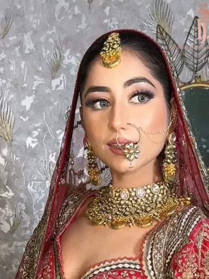 A candid shot of a bride looking away, showcasing her beautiful side profile and the detailed makeup work around her eyes.