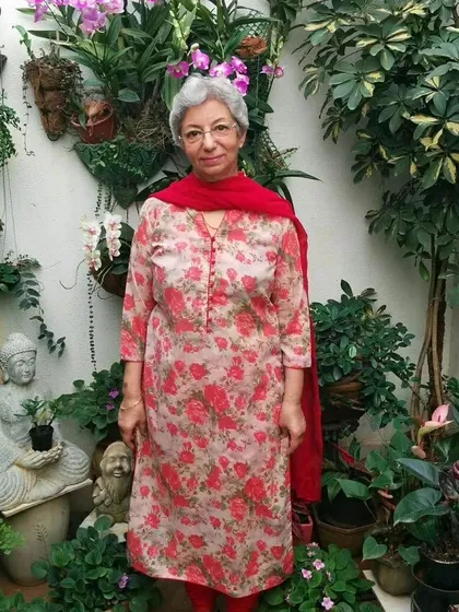 A member of our plant parent community surrounded by her beautiful garden, featuring a stunning collection of orchids. Gardening is a wonderful way to practice self-care and connect with nature.