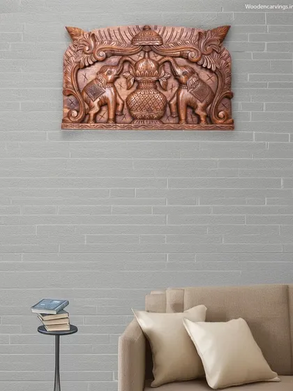 This 24-inch wall panel features a Pooja Gopura Kalasam flanked by two elephants (Gaja). It is designed as a decorative entrance piece, bringing auspicious symbolism to the doorway of a home or pooja room.