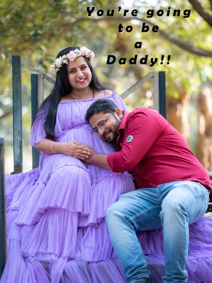 A fun and loving couple photo with the dad-to-be listening to the baby bump. The text "You're going to be a Daddy!!" adds to the joy.
