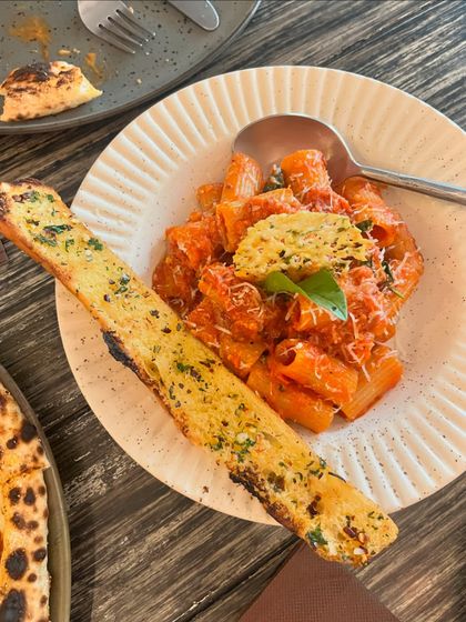 My Rigatoni Arrabbiata, served with a giant slice of garlic bread. It's a hearty and satisfying meal that's perfect for any occasion.