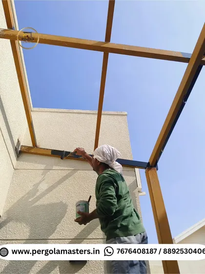 Our technician applies a primer coat to the metal beams of a pergola frame. This crucial preparation step ensures excellent paint adhesion and long-term protection against rust and corrosion.