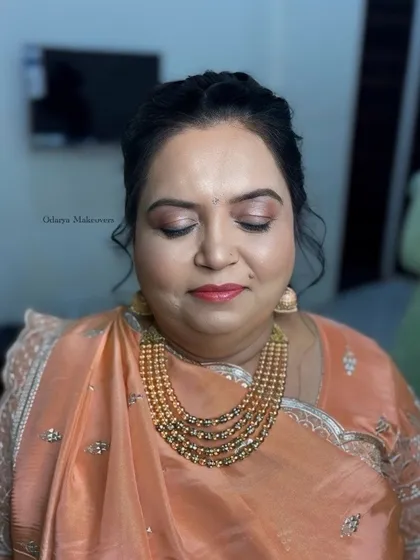 A close-up of the Sangeet makeup, showing the shimmery peach eyeshadow and the flawless skin finish.