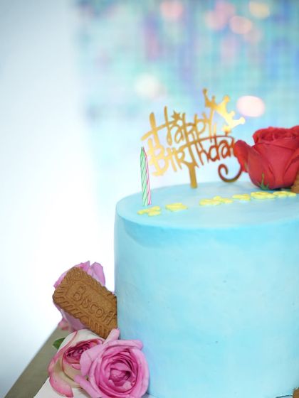 A detailed shot of the birthday cake, adorned with a 'Happy Birthday' topper, ready for the big moment.