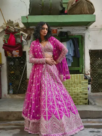 A full shot of the modern pink lehenga with geometric silver embroidery. This outfit is designed to shine as bright as the love it represents.