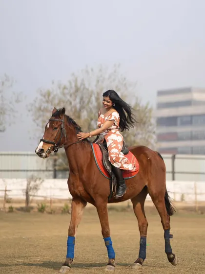 A rider and horse in perfect harmony, walking gracefully across the field.