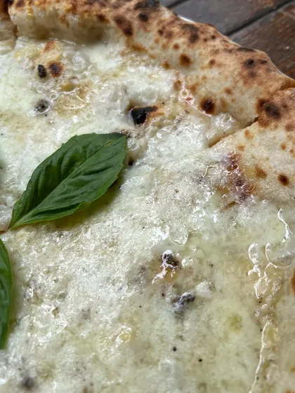 A close-up of the melted cheese on our Bianca Truffle pizza. It's a beautiful sight.