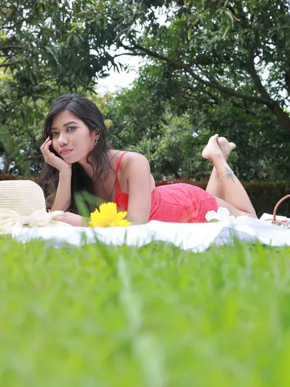 A playful and engaging portrait from the picnic shoot, with the model lying on her stomach.