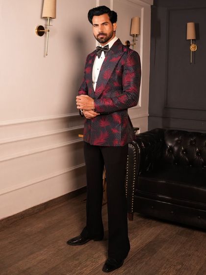 The side profile of our red and black patterned tuxedo, showing its clean lines and modern fit.