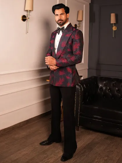 The side profile of our red and black patterned tuxedo, showing its clean lines and modern fit.