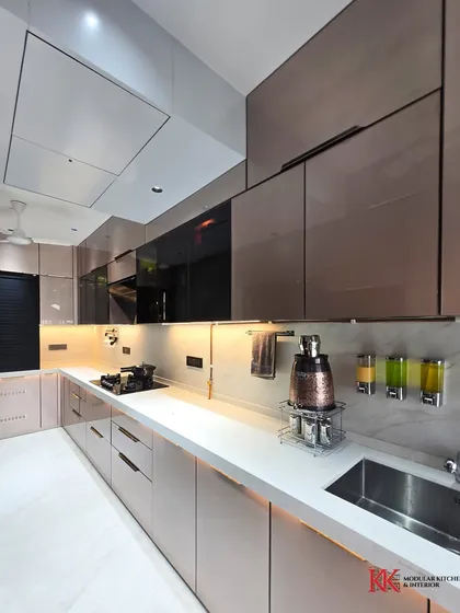 This image highlights the loft storage with a bi-fold lift-up shutter, providing easy access to the top-most cabinets. We ensure no space is wasted in our kitchen designs.
