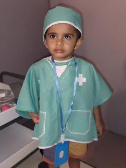 A future doctor is on duty. Our pretend play areas allow children to explore different professions.