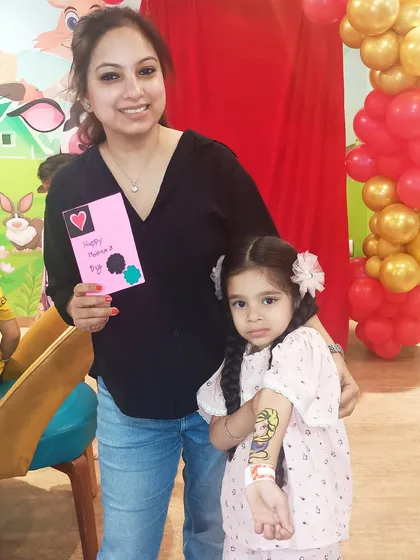 I love creating special moments for families to share. A mother and daughter proudly show off her new face paint and the handmade card she created during our Mother's Day workshop.
