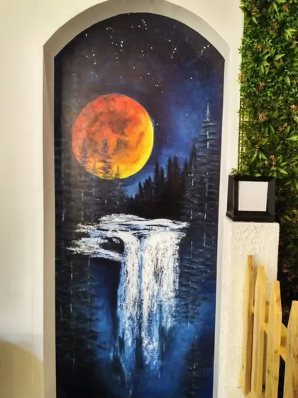 This night sky landscape was painted on a spa door. The glowing full moon, the dark forest, and the cascading waterfall create a sense of mystery and tranquility, perfect for a space dedicated to relaxation.