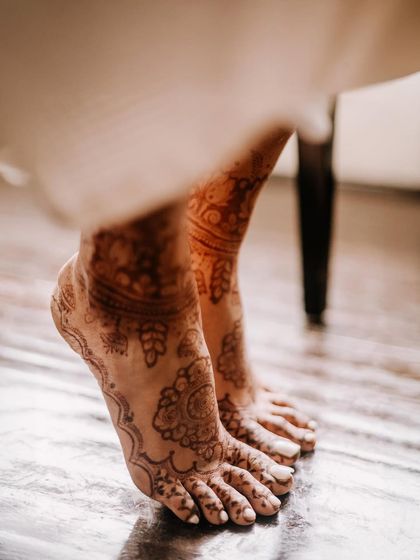 An artistic shot of the bride's feet, adorned with beautiful mehndi. I find beauty in the details and the quiet moments of the day.