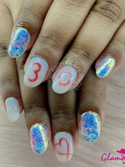 A fun and quirky set combining multi-colored glitter nails with accent nails featuring hand-drawn numbers and hearts.