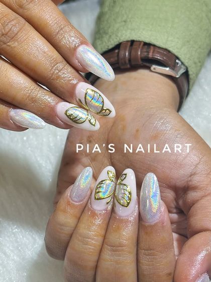 Trendy holographic nails with gold butterfly accents. The holo effect creates a rainbow shine that is always an eye-catcher.
