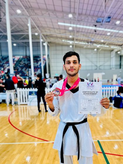 Holding the Bronze medal and certificate at the Australia Open G-2 championship. The hard work pays off on the international stage.