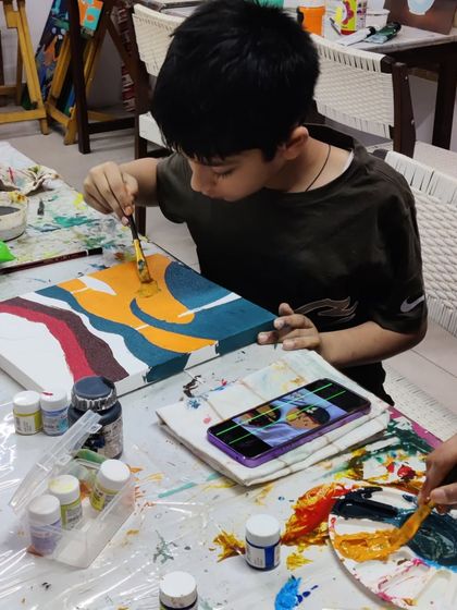 Scenes from our kids' acrylic workshop, where students learn to create bold and colorful landscape paintings.