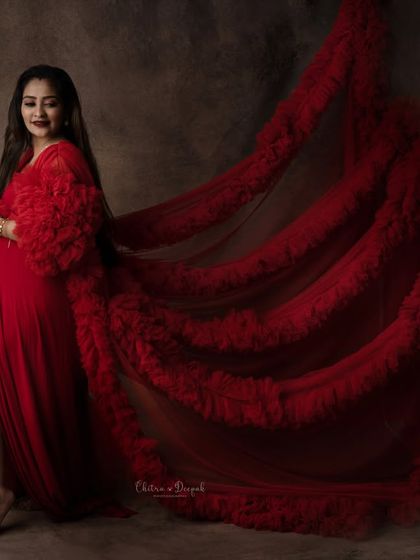 A dramatic fabric toss with a fiery red gown. The movement and rich color against a dark background create a truly captivating image.