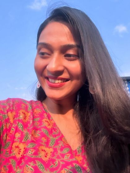 A happy selfie against a clear blue sky.