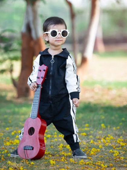 This little rockstar is ready for her close-up. The 'Budding Musician' theme lets kids play and have fun, and I get to capture their cool and confident personalities.