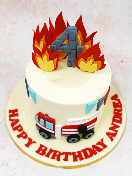 Another view of our fire theme cake, showing the dynamic flame toppers and festive bunting.