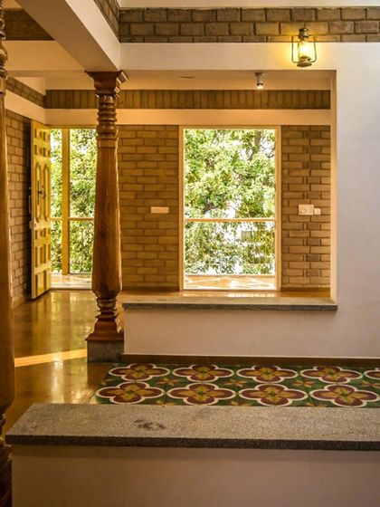 The proportion of the wooden columns to the height of the room and the size of the floor tiles creates a well-balanced and grounded space.