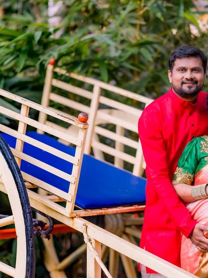 A joyous maternity photo with the rustic bullock cart prop, blending traditional elements with the beauty of nature.