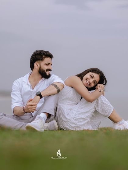 A relaxed and happy moment together. Sitting back-to-back allows for a comfortable yet connected pose that feels natural and unforced.