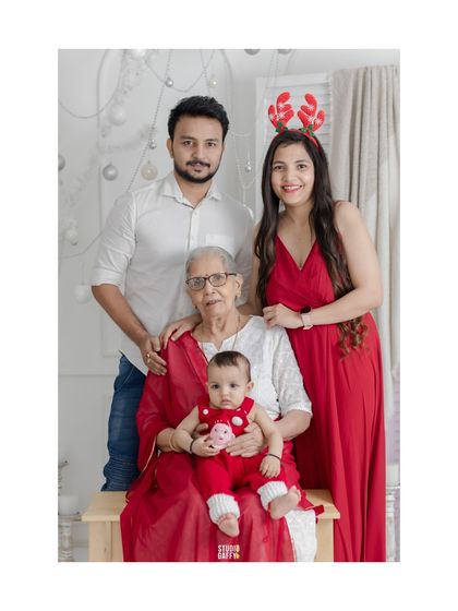 Three generations of love. This beautiful Christmas portrait includes dadi (grandmother), capturing a precious multi-generational family moment.