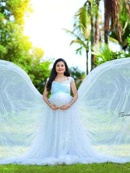 A beautiful butterfly pose with a light blue gown, creating a sense of lightness and grace.