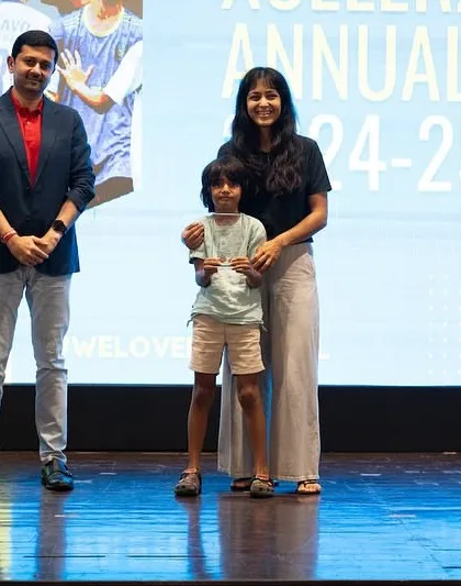 A young player from our U7 Xcelerate team receiving his award.