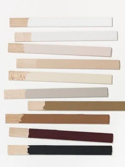 The details make the design. This image shows a selection of wood samples with different paint and stain finishes, representing the careful process of choosing the perfect colors and materials to create a cohesive and beautiful space.