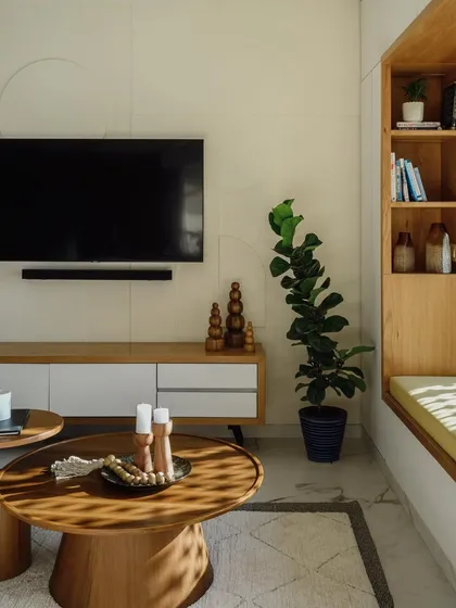 This living room setup features a set of two solid wood coffee tables and a sleek, minimal TV console I built. The round tables have a sturdy pedestal base, offering a modern look that complements the room's calm aesthetic.