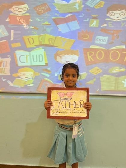 A student presents her acrostic poem for "Father" during Literacy Quest Week. This activity encourages creative writing and helps children express their feelings in a structured way.