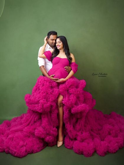 A beautiful portrait of the couple, perfectly coordinated. The vibrant pink of her gown and his simple white shirt create a fresh and stylish look.