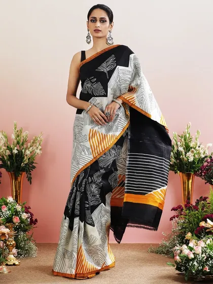 The full view of the black and white leaf print saree, a chic and contemporary choice.