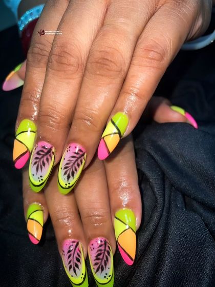 Another view of the neon leaf nail art, highlighting the bright colors and sharp lines.