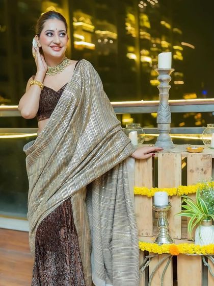 Another shot of a guest enjoying the Diwali decor. The soft glow of the candles on the wooden crates adds to the warm and inviting atmosphere of the festival.