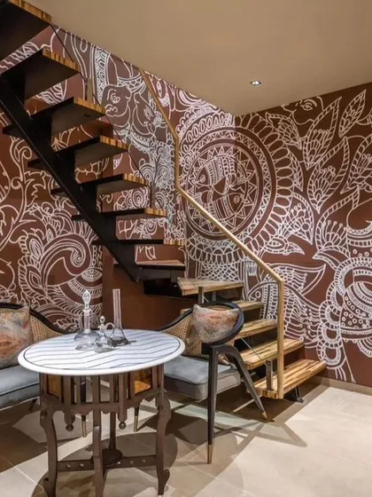 The full view of the staircase mural, demonstrating how we can transform a functional space into a beautiful narrative journey.